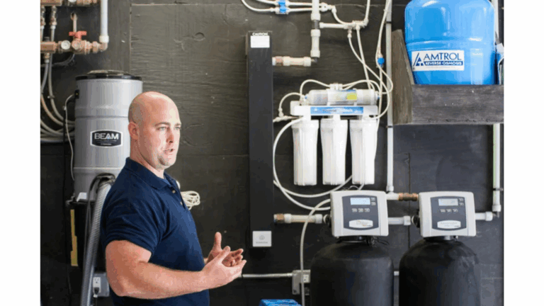 Service technician showing off a water softener system