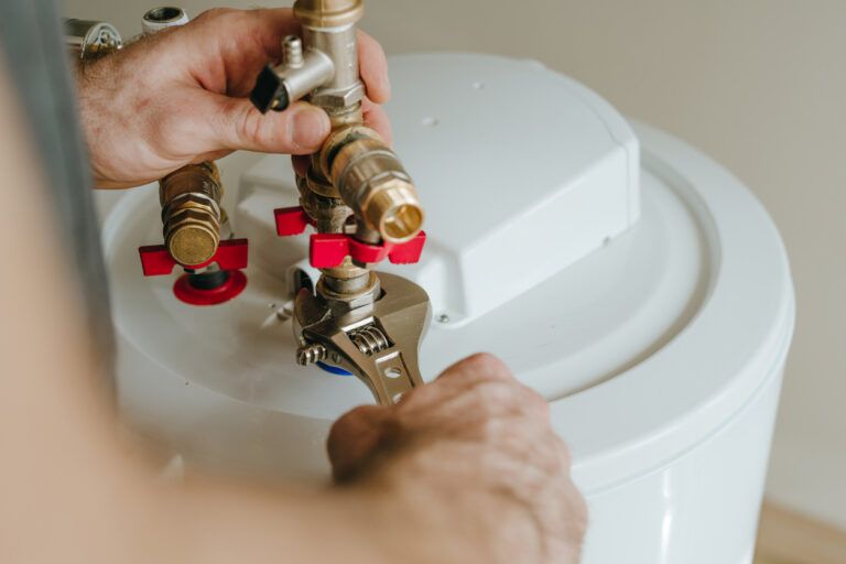 Installation of plumbing fitting of water heater by master using wrench